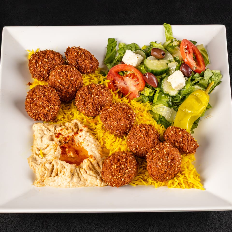 Falafel with rice, hummus, and salad